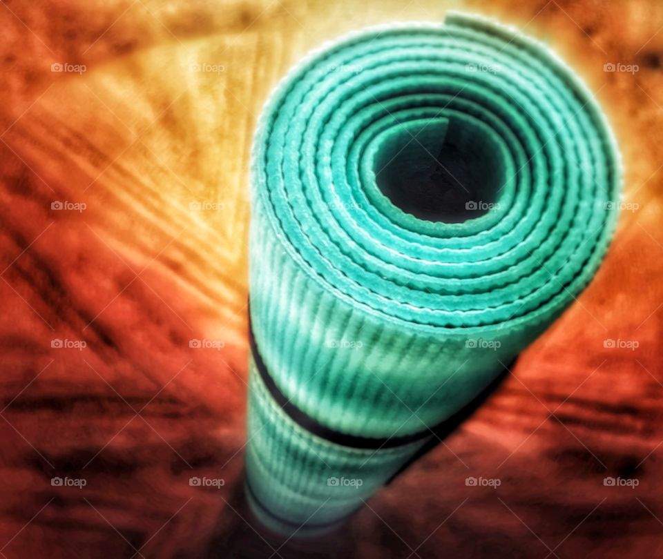 Yoga mat superhero pose from above rolled up turquoise powerful spiral