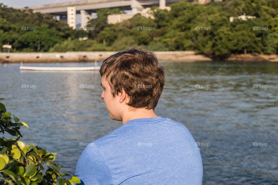 A teenager boy watching the sea