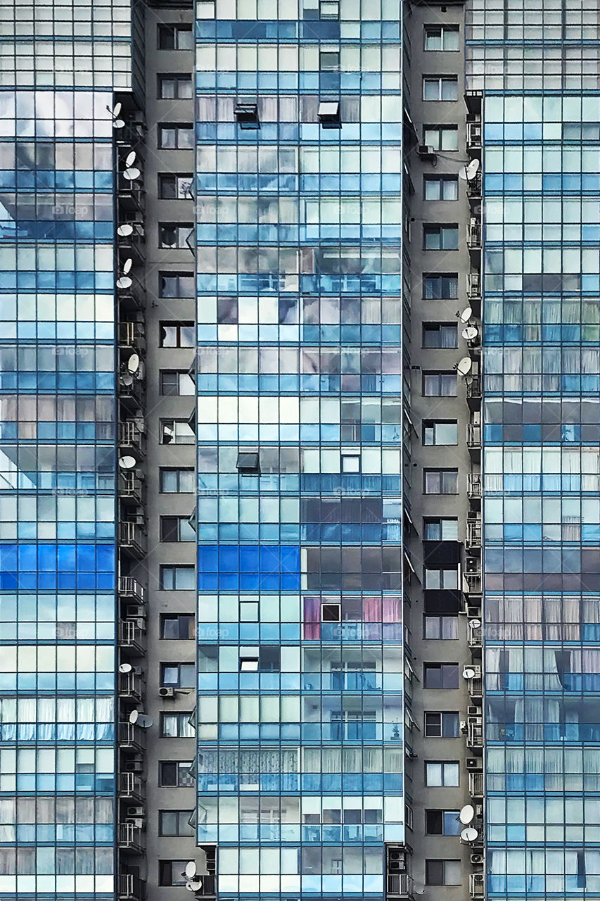 Mirror windows of the modern building with blue sky reflection 