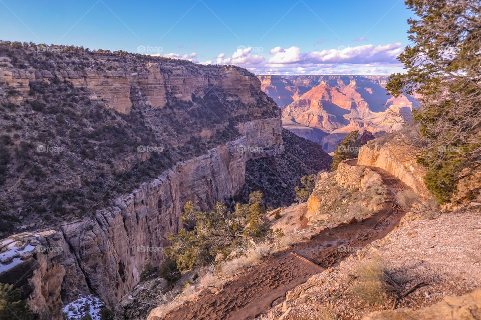 Walkway leading down the Grand Canyon on a sunny day.  