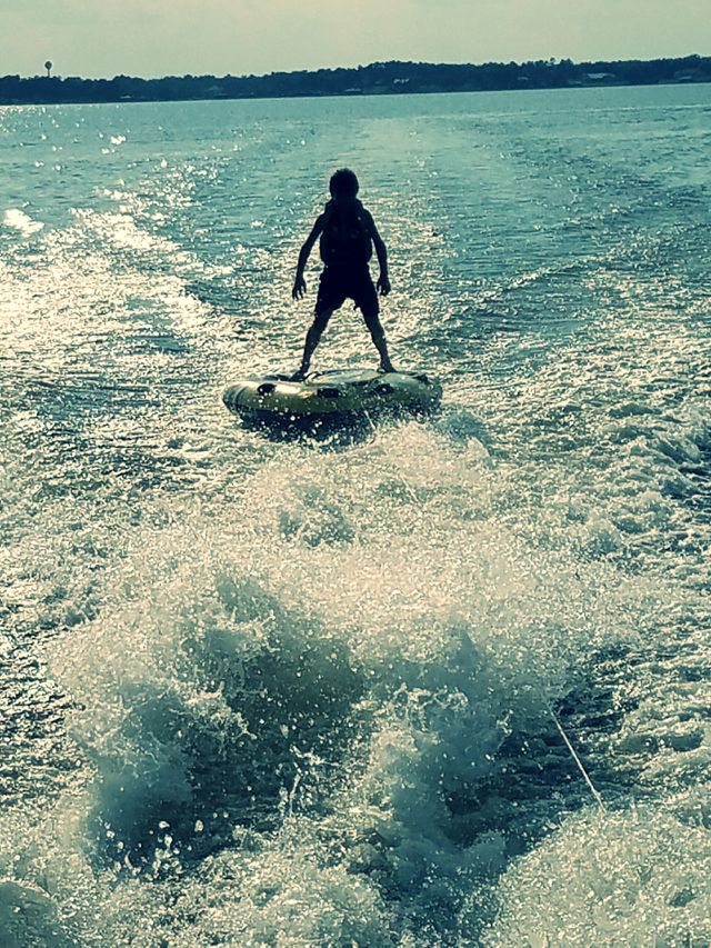 tubing on lake at sunset