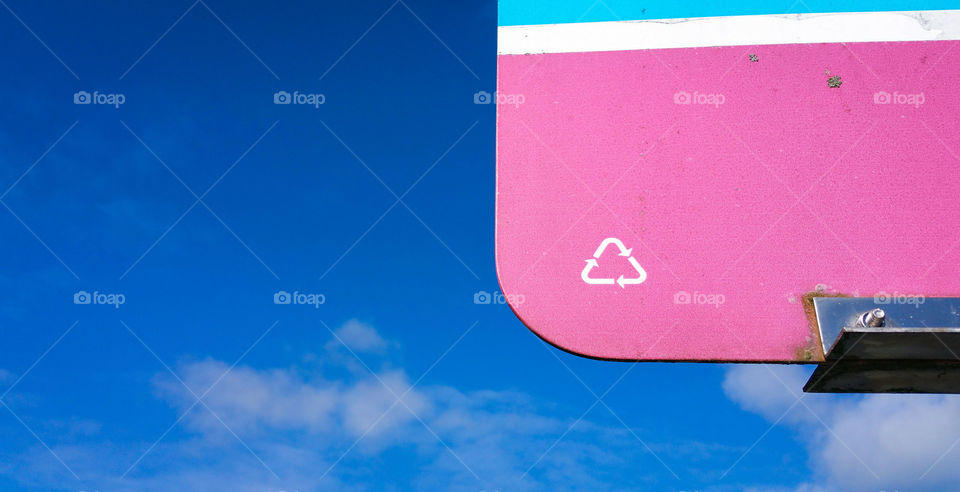 Pink sign against the blue  sky