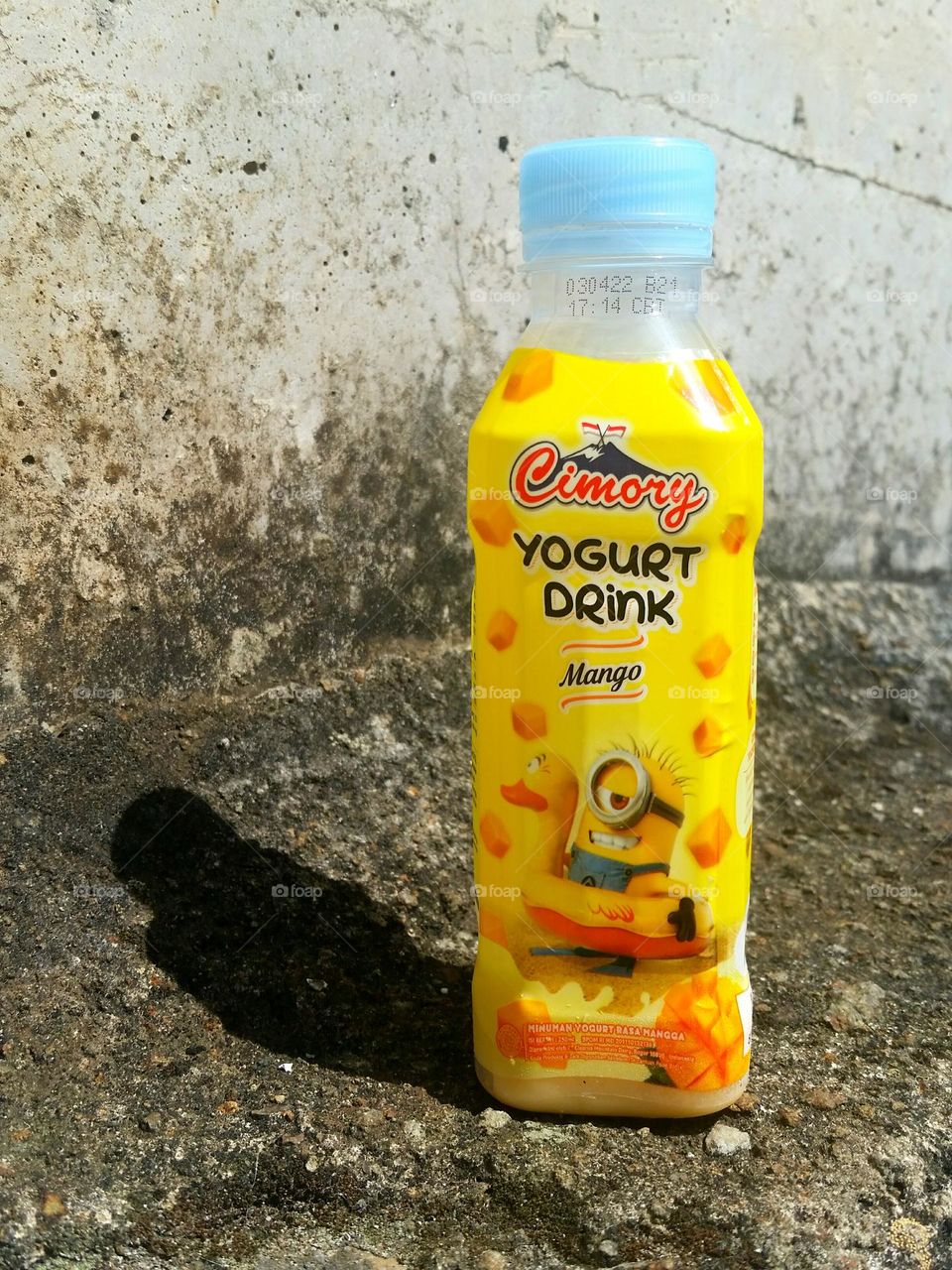 Yogurt bottle in concrete fence...
