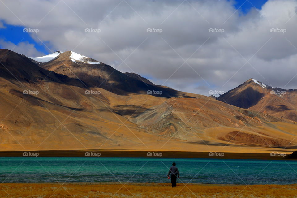 in solitude with mighty mountain and calmness of the lake