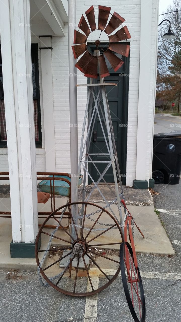 old windmill . wagon wheel and wind mill