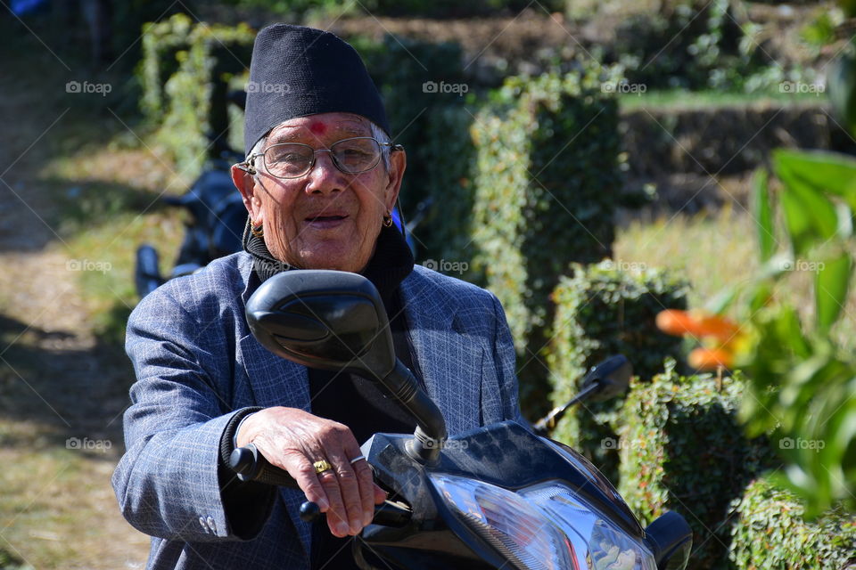 90 years old man riding scooter