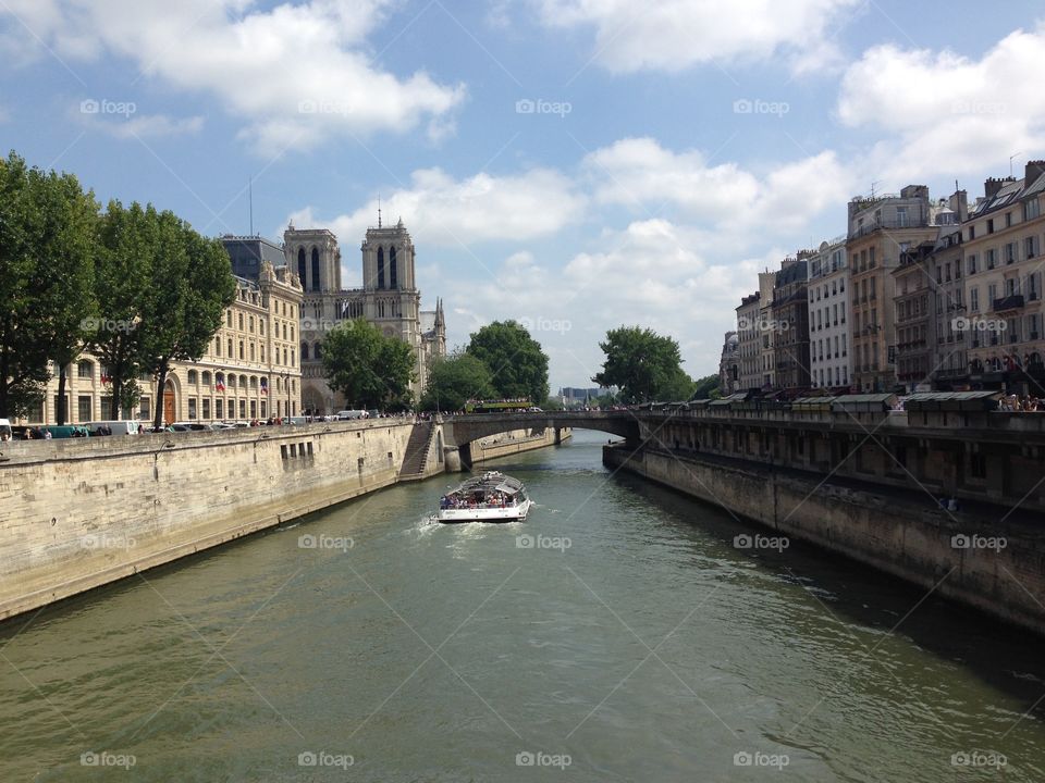 Obstructed view of Notre Dame de Paris by a bridge over the Seine. 