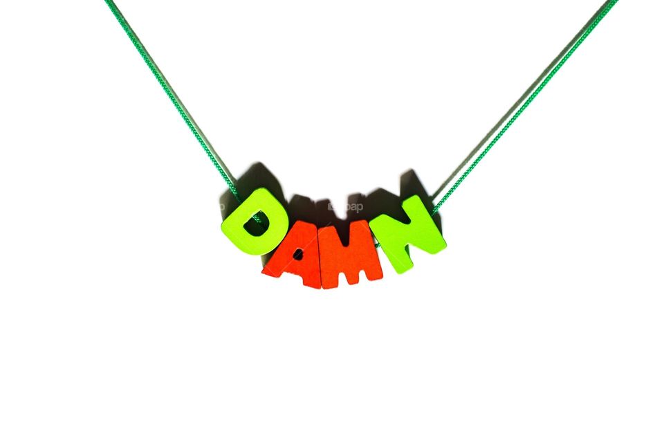 Word damn on string as necklace by wooden letters 