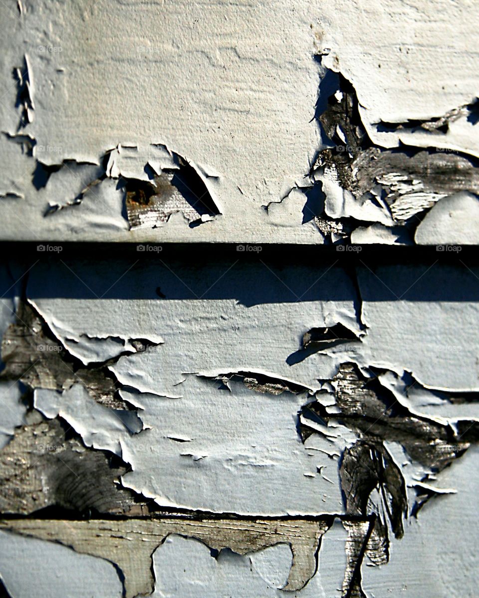 Cracking paint on wooden fence
