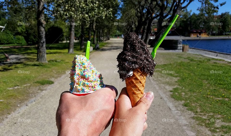 An ice walk in the park!. Hands holding ice cream.