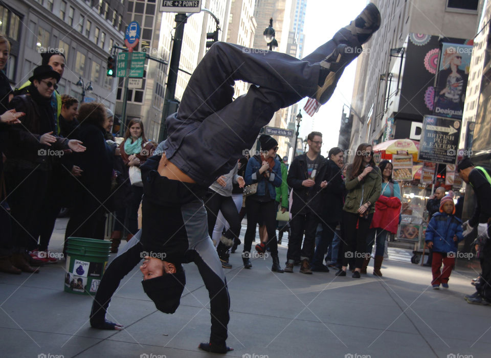 A street performer wows passerby's with his breakdancing ease in the Big Apple
