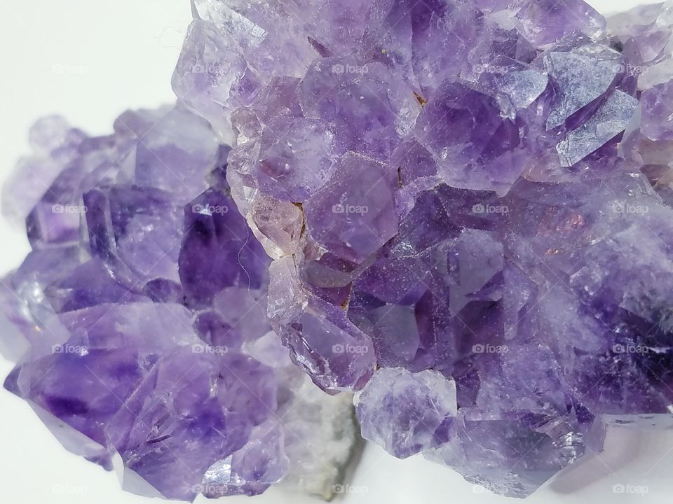 Close up photo of purple amethyst crystal.