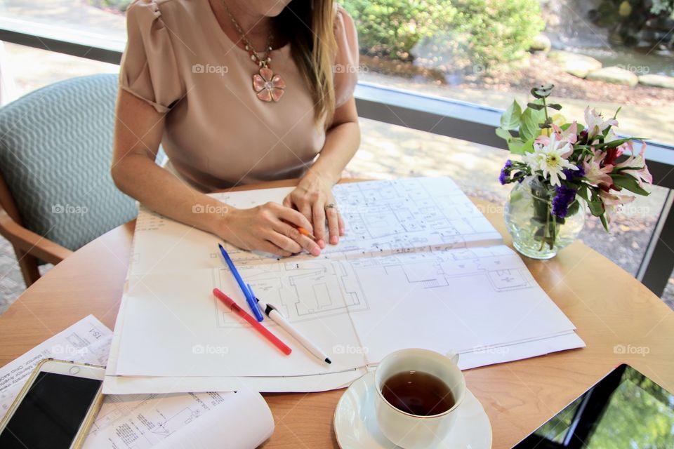 Woman working on blue prints