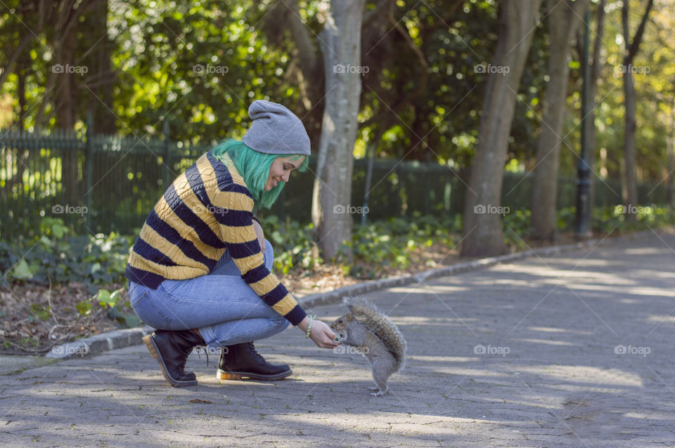 Alternative girl feeding squirrel