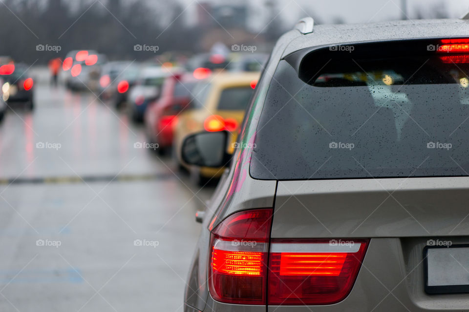 Car traffic jam queue intensive traffic hours. Rear view.