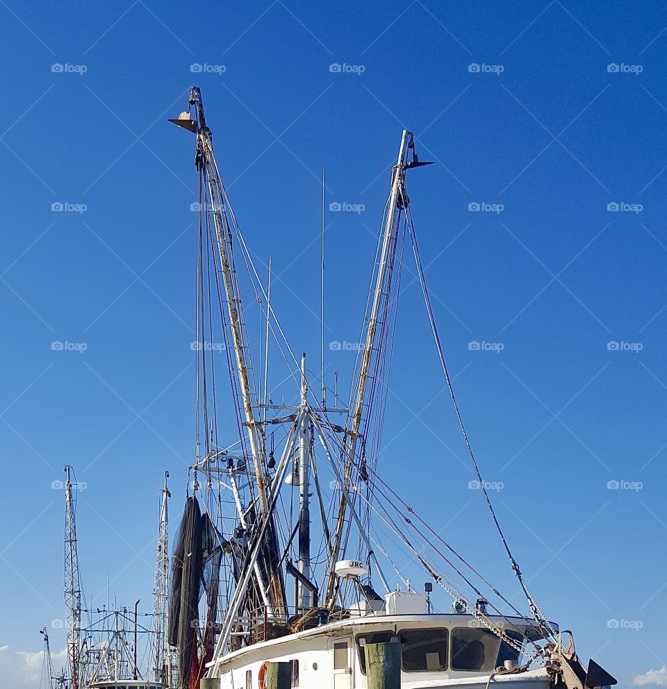 Commercial oyster boat and clear blue sky 