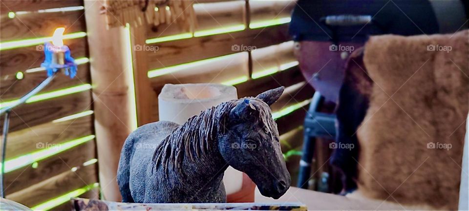 „Ron‘s Whiskey Lounge“ in „Bavaria“, Germany is decorated rustic „Country Western“ style. It has leather holsters and saddles hanging on the wooden walls and this miniature statue of a horse. „Yippee ah yeah“ I say. 2024. Hypnotic Productions