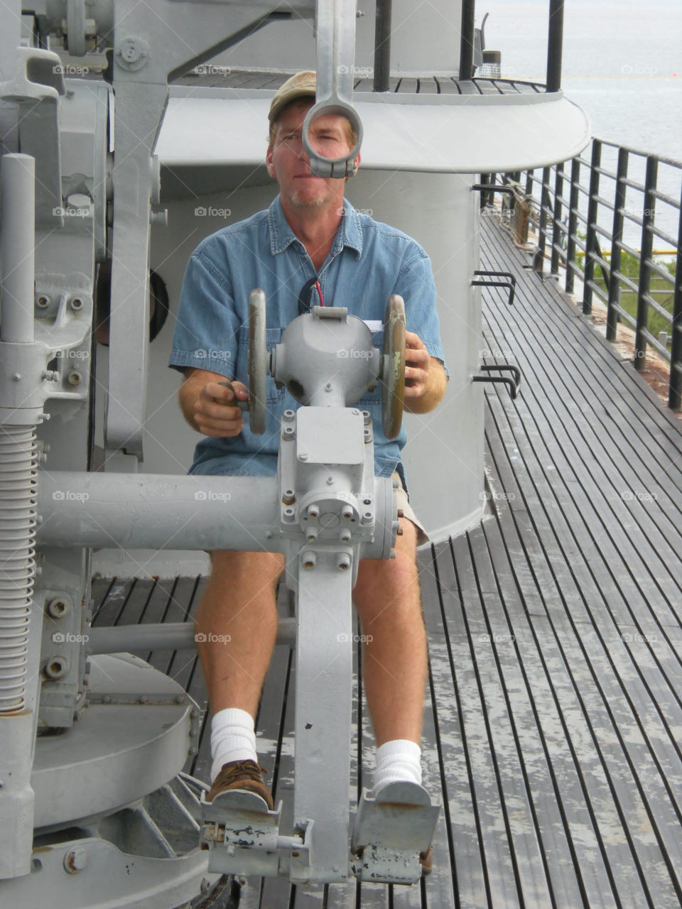 Man playing with gun on the USS Alabama battleship memorial park mobile Alabama