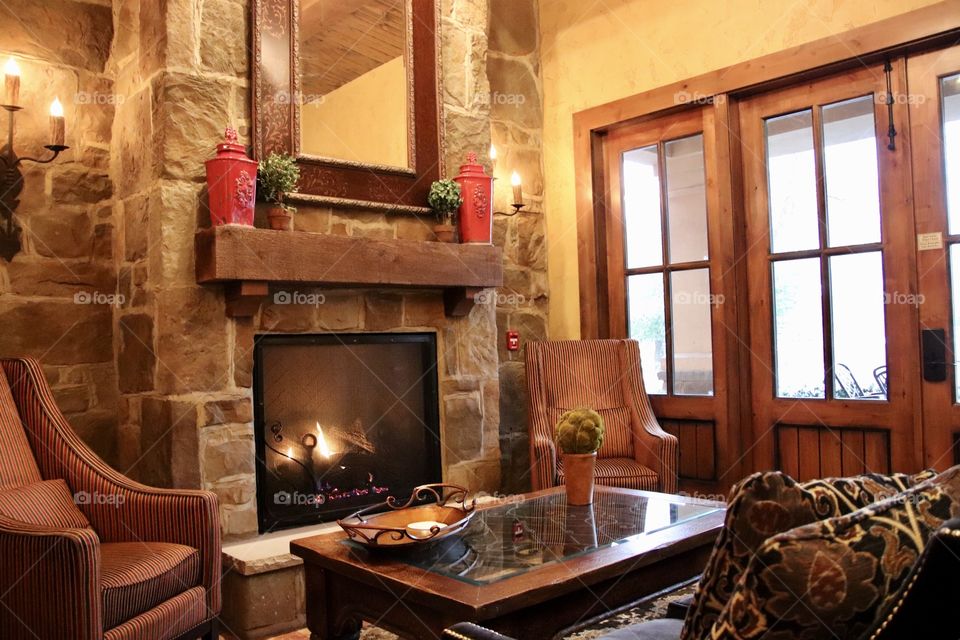 Beautiful living room with fireplace and wooden doors 