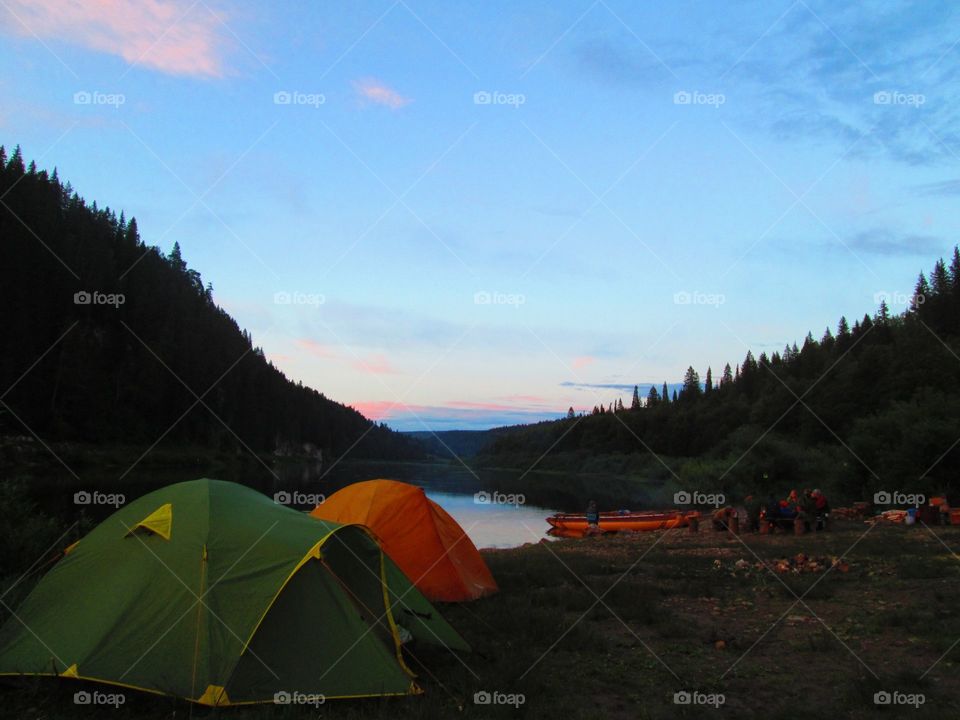 Tent camp, river and sunset
