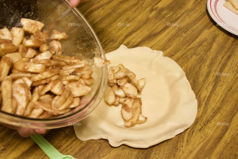 Pouring apples into pie shell