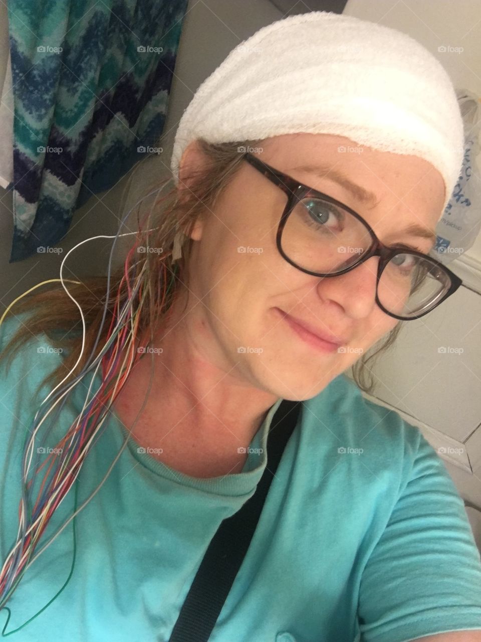 Young girl with medical EEG leads on head