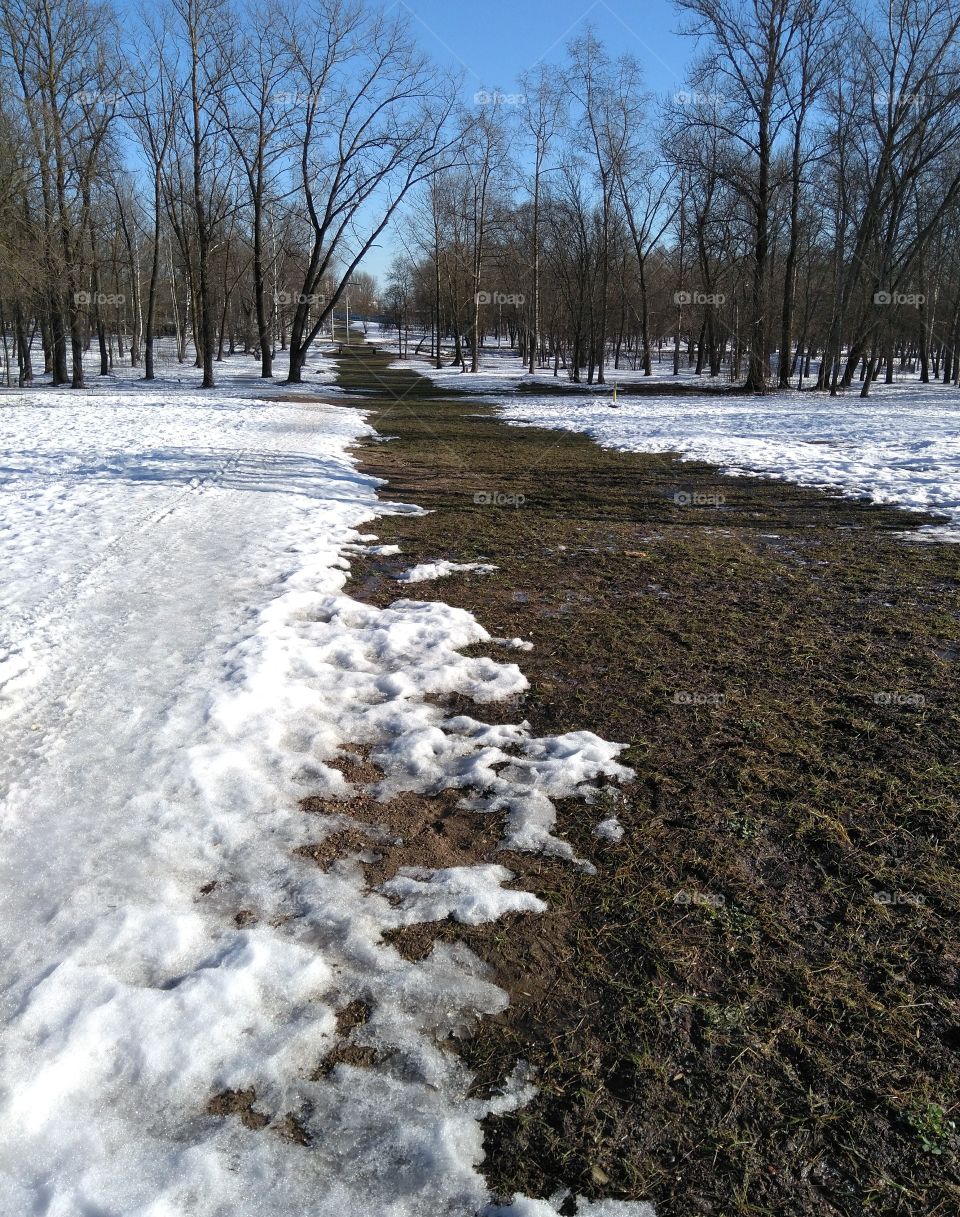 winter and spring landscape in the solar park