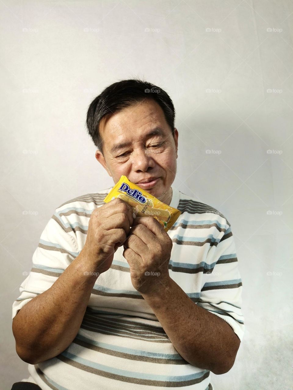 A Chinese man with a candy bar.