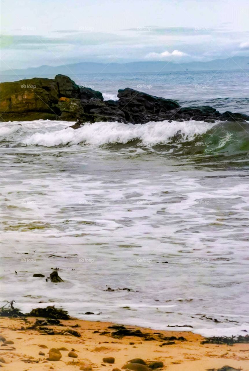 Scottish rocks with the sea and beach