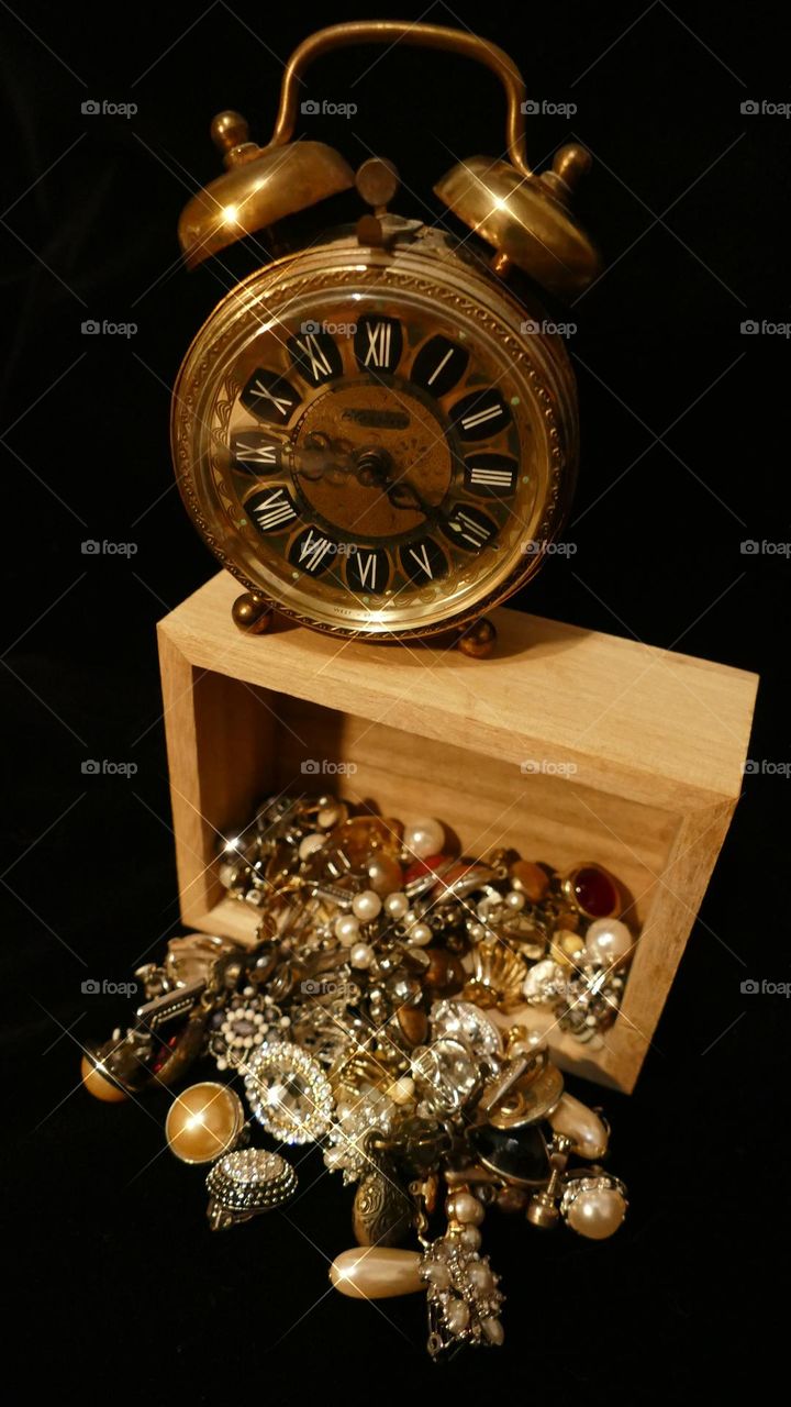 Old fashioned double bell wind clock and Grandmother’s earrings