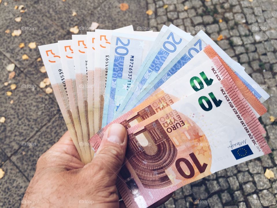 Man spreading euro money