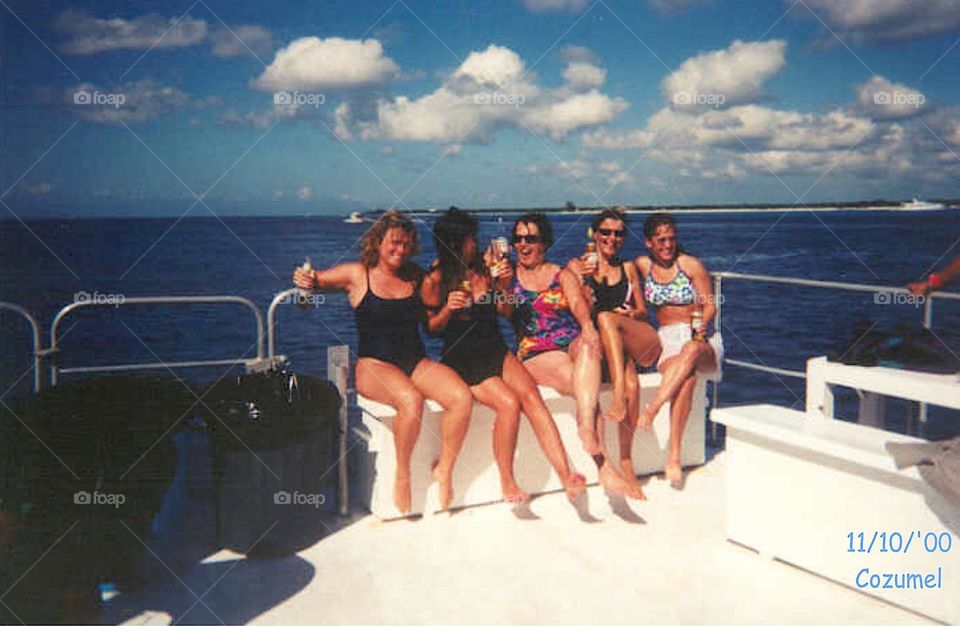 Summer activities in the USA. Boating with friends and having a great time. Girlfriends partying on the deck of a boat!