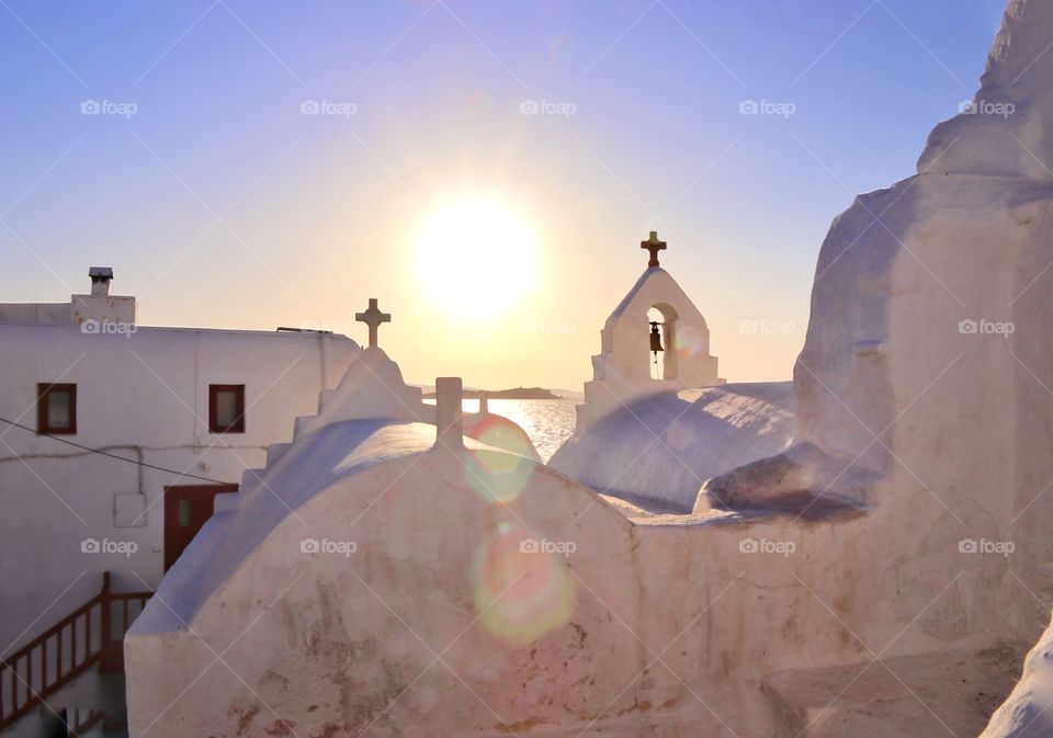 White roofs of a church building on sunset background