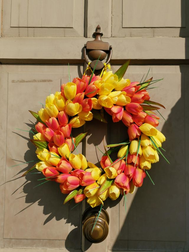 Easter time. Easter wreath on the door. 
Doors decorating. Tulips derogation. Springtime.