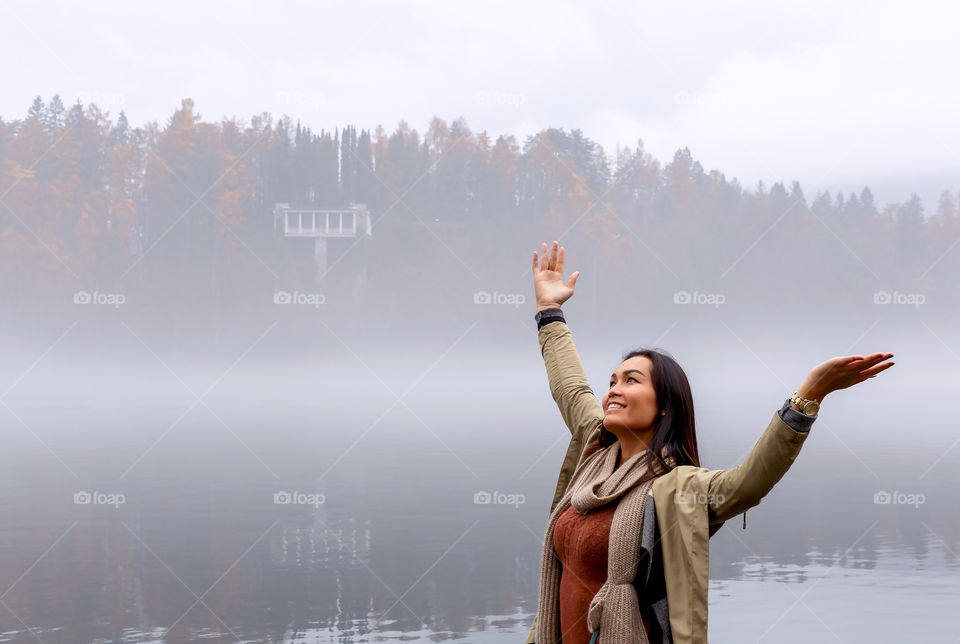 Smiling asian woman at lake side