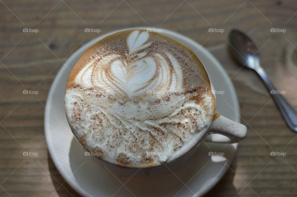 coffee art on a wood grain table
