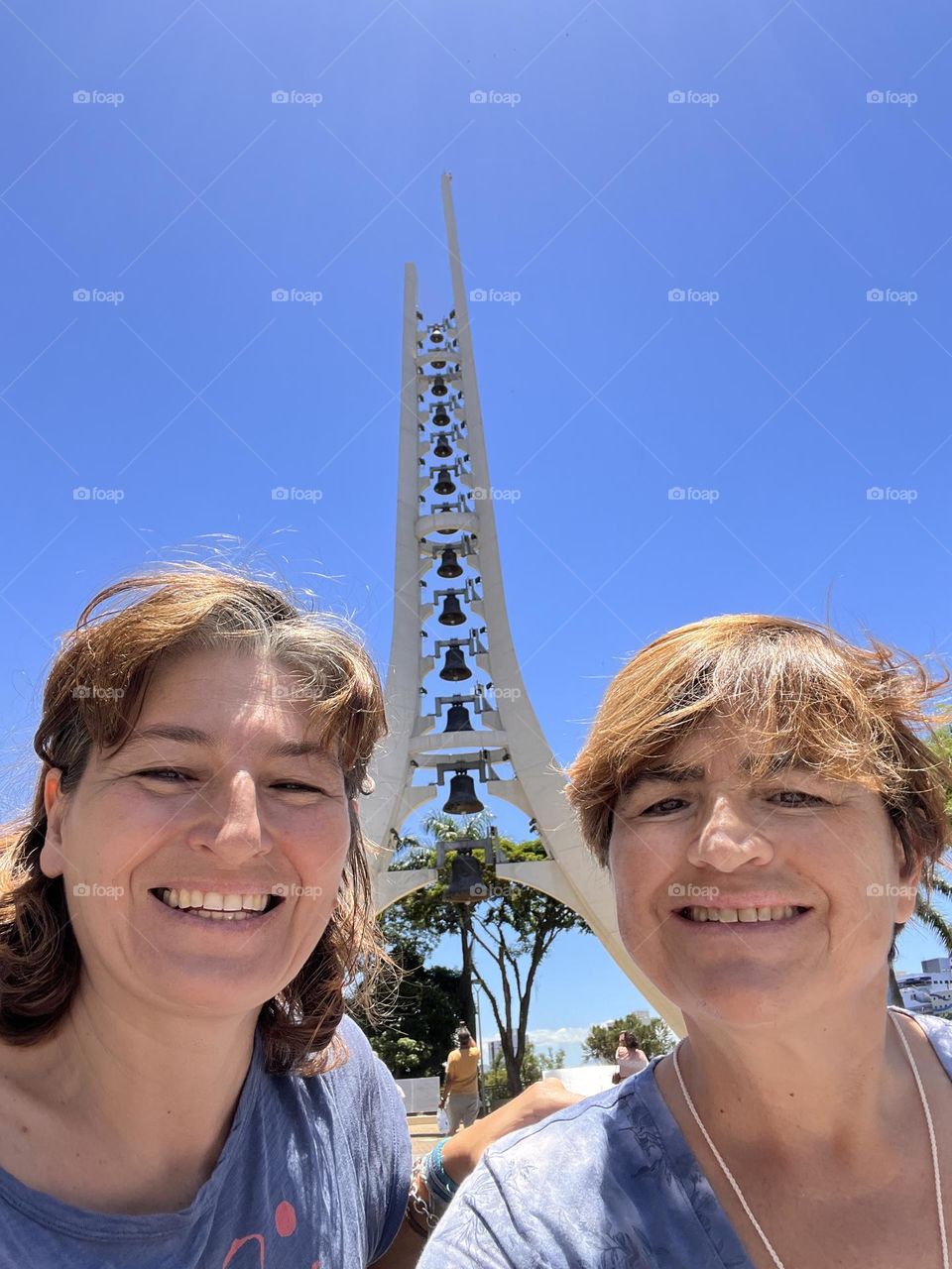 Woman against bells tower 