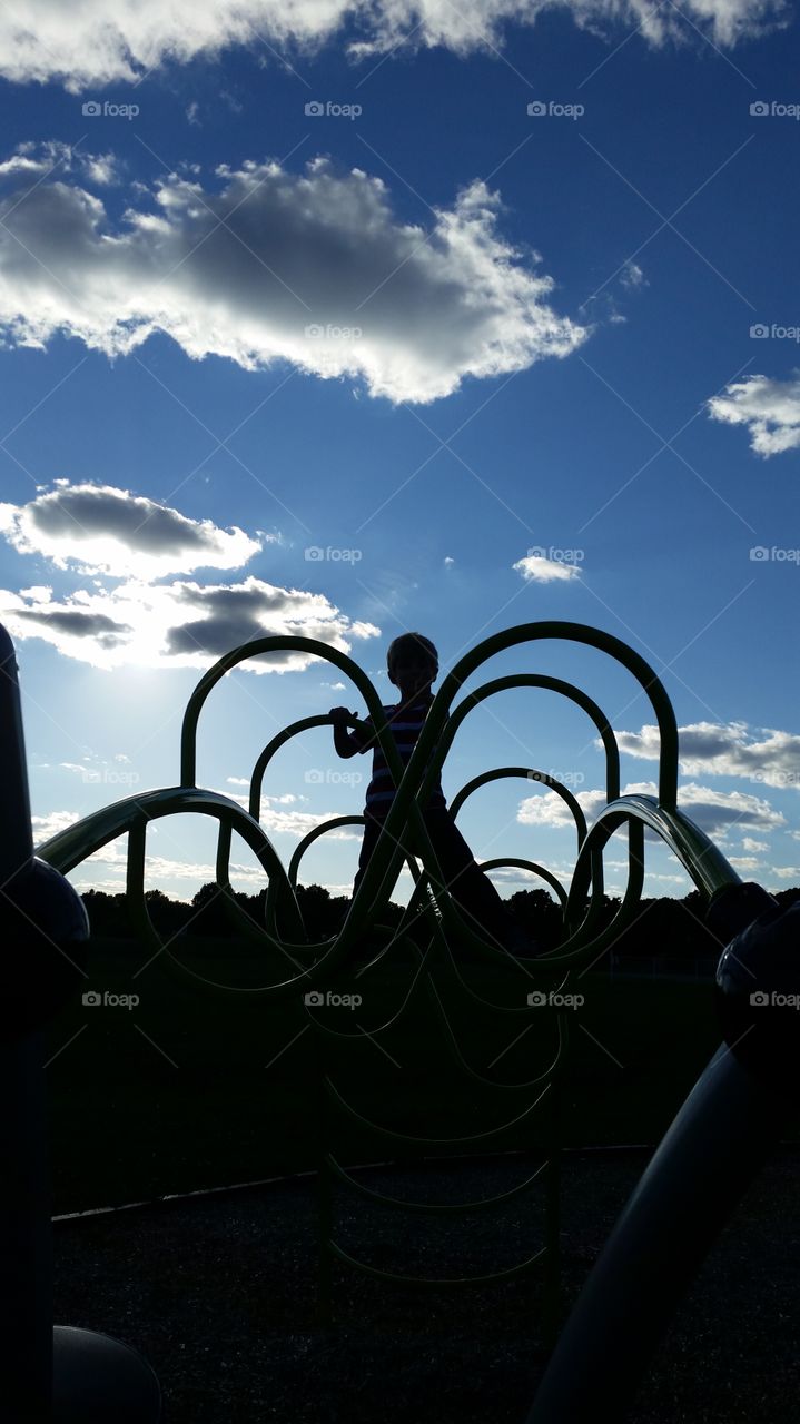 dusk playground. child playing at Golden hour