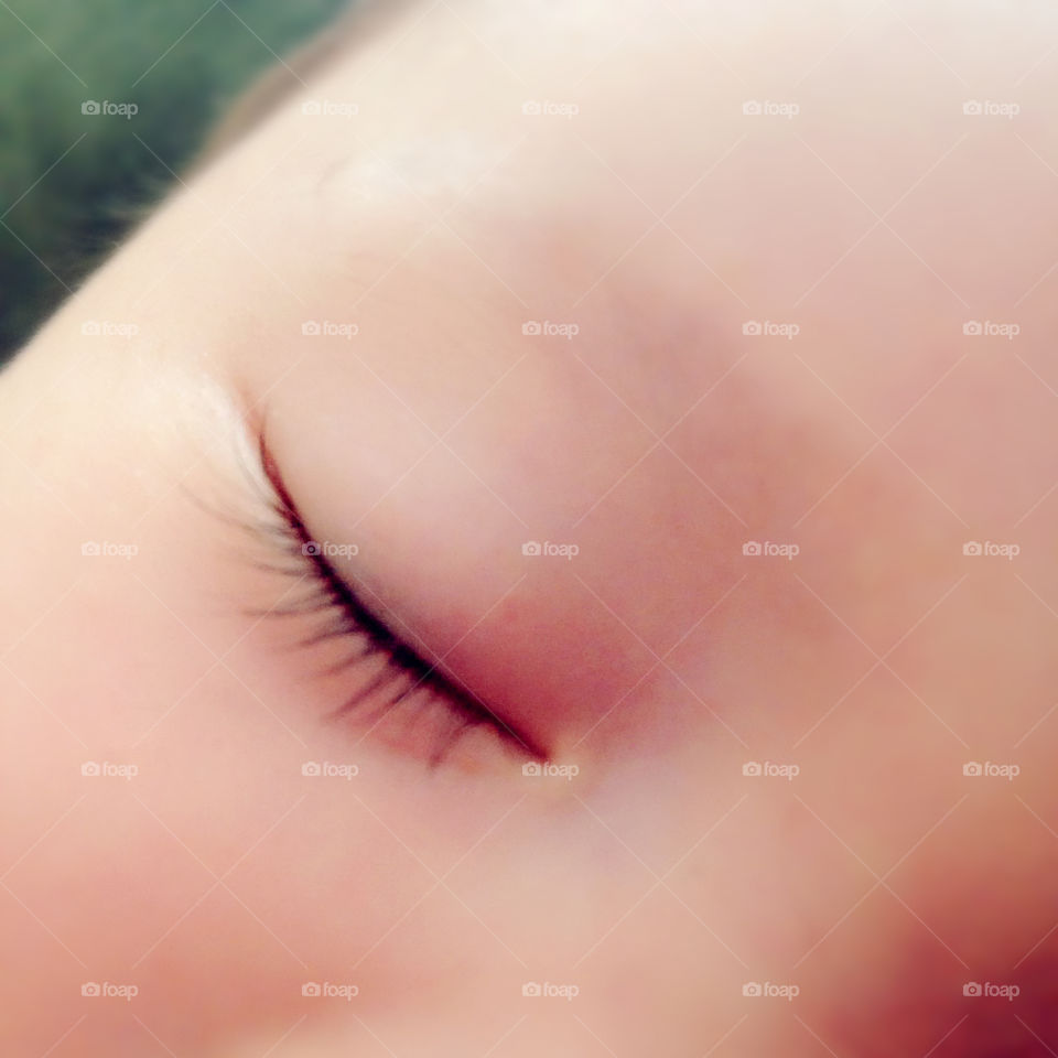 Sleepy baby with long eyelashes