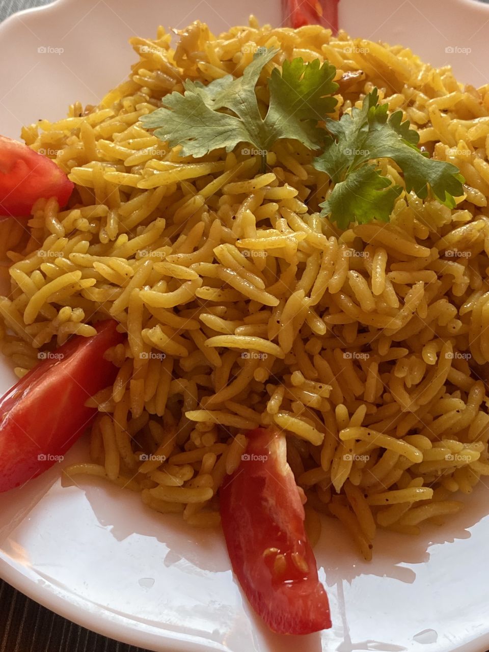 Rice with tomatoes on a white plate