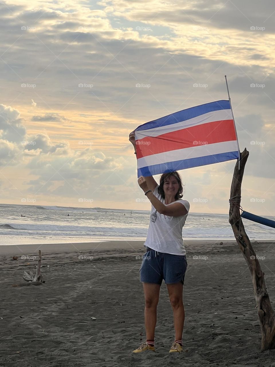 Woman with flag in the beach 