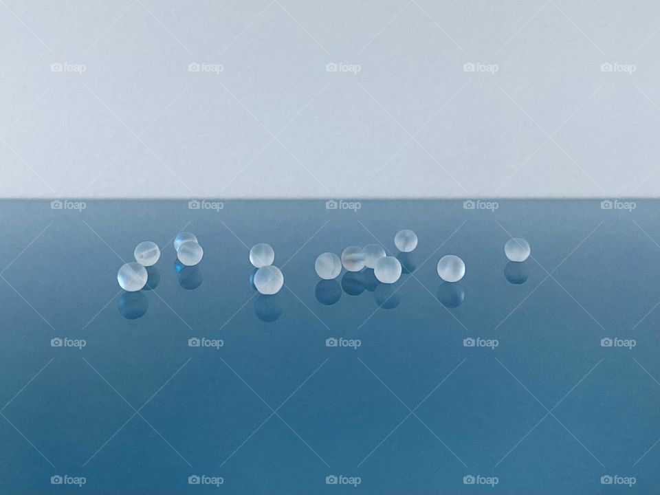 Glass beans on a glass table 