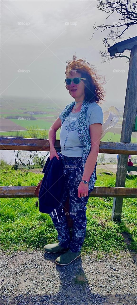 This young lady has finally reached the summit of the “Bogenberg”, a mountain in the vicinity of the township of “Bogen” and this is why she’s taking a break overlooking the river “Danube” down in the valley. 2024. Hypnotic Productions