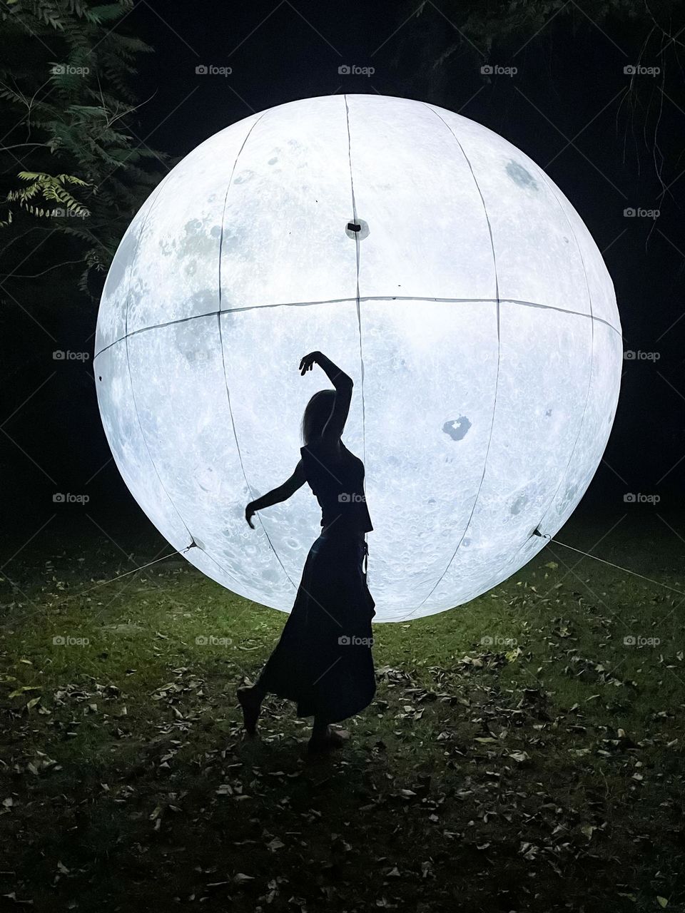 Woman Dancing in Front of the Art Installation Moon