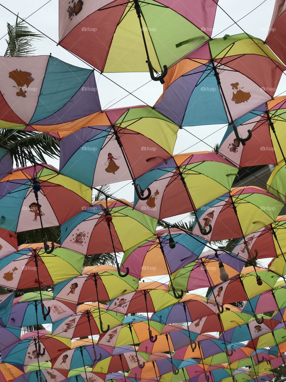 Umbrellas in the sky with a dancing lady design in each umbrella.