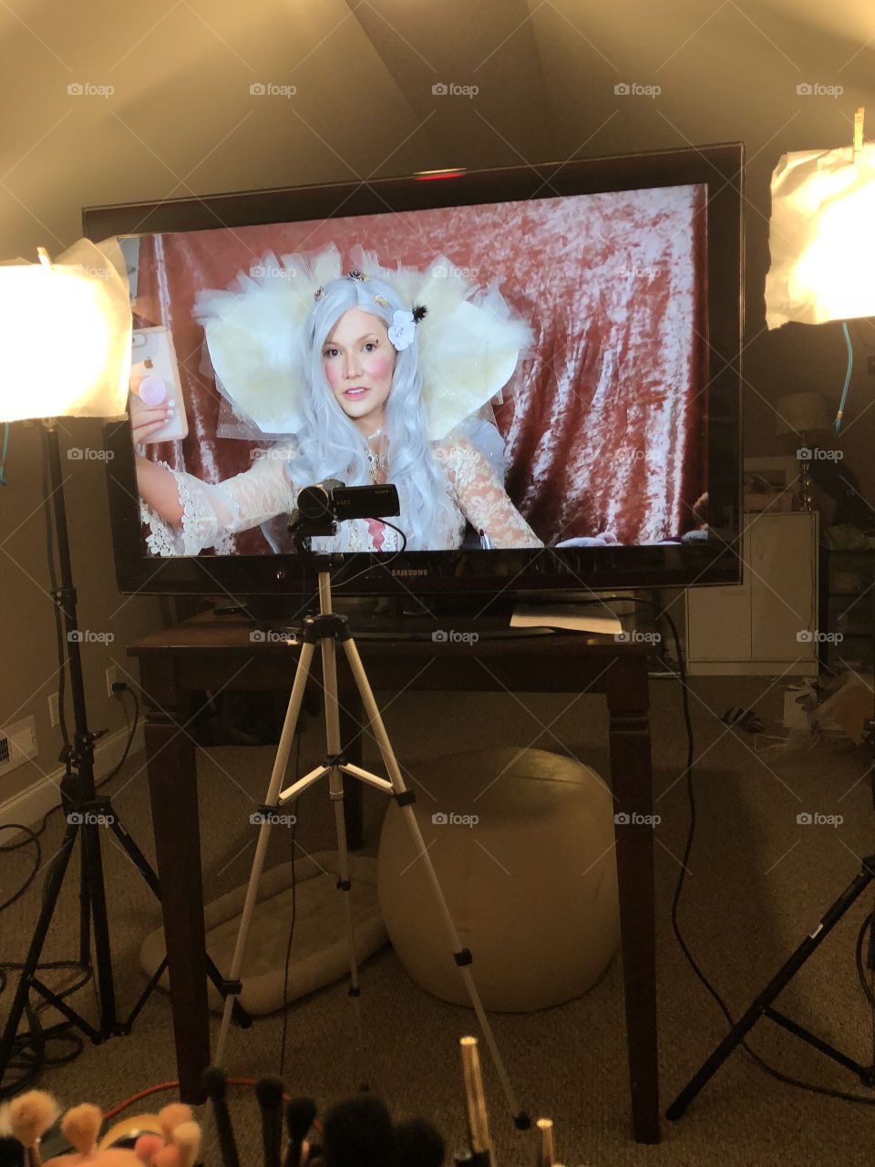 Modern day Renaissance courtesan takes selfies with iPhone 8+ on big screen tv with camera and tripod.  Isn’t that crushed pale pink velour background just stunning?