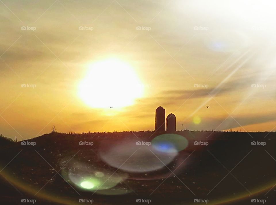 Driving the back Roads  enjoying  everything around us. A beautiful sunset on a farm