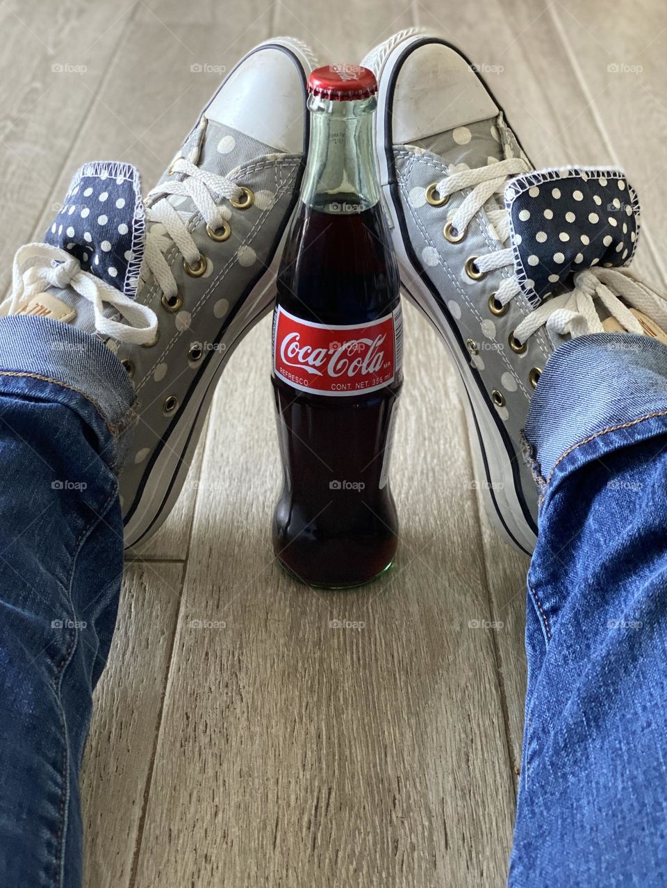 Polka dotted shoes and a cold drink