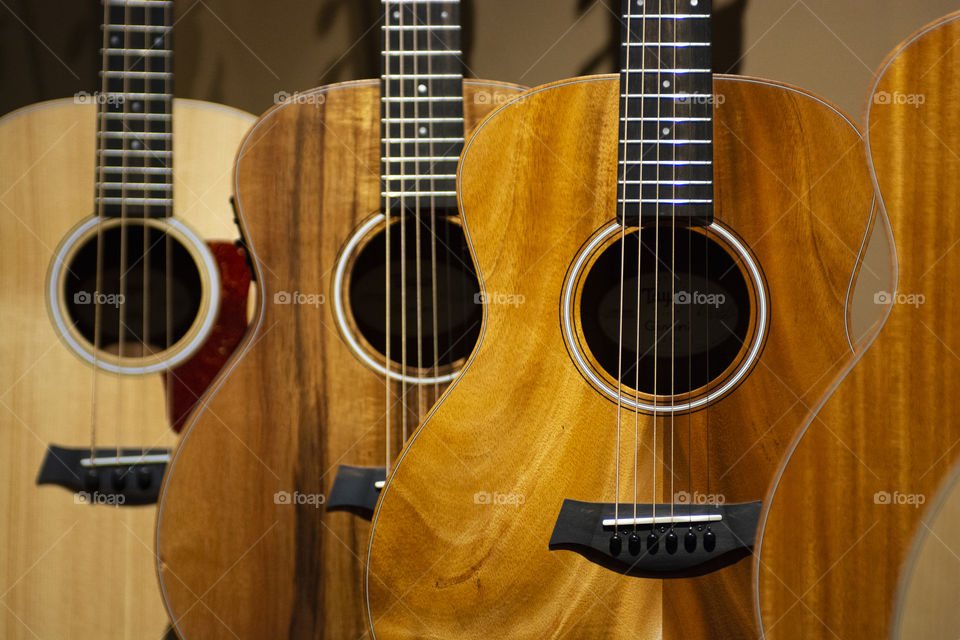 Acoustic guitars lined up in a row