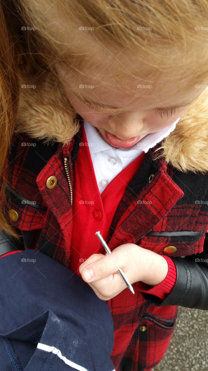 playful child. pretending to have a nail in her thumb.